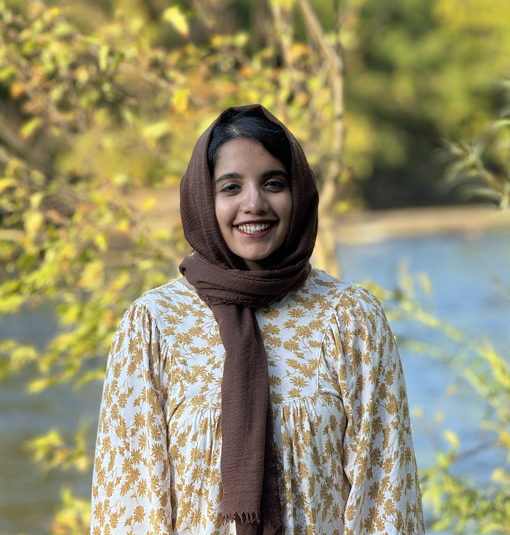 A headshot of Hira Jamshed standing in front of a river